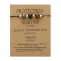 Detail of Tiger's Eye, Black Tourmaline, and Pyrite stone wish bracelet on kraft card - 3772 Round Bead