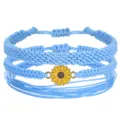 Juego de pulseras bohemias de cordón encerado azul hechas a mano con dije de girasol amarillo - Set de tres piezas / Azul claro