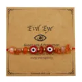 Handgefertigtes rotes Evil Eye Armband mit orangefarbenen Natursteinen und Kupferperlen - Rot