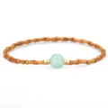 Elegant Chinese style bamboo joint bracelet with olive pit beads and central green bead - Amazonite