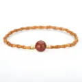 Traditional Chinese style olive pit bamboo joint bracelet with a red strawberry quartz bead - Red Jasper