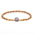 Handcrafted bamboo joint olive pit bracelet with a central translucent purple stone bead - Purple Crystal