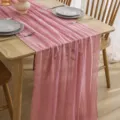 Close-up view of pink crinkle cheesecloth table runner detail, perfect for elegant wedding decor. - Peach No. 16