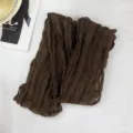 Detail view of a dark brown crinkled scarf, showing the fine pleated texture and fabric. - Dark Coffee