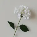 Detailed macro shot of a single white 3D printed artificial hydrangea with leaves - White