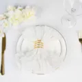 Elegant white Bohemian pleated Bali gauze napkin with a gold spiral napkin ring on a plate - 50x50cm / 白色16号