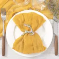 Elegant silver reindeer napkin ring paired with yellow gauze fabric for wedding table decor - 50x50cm / No. 29 Ginger Yellow