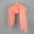 Solid coral pink cotton linen bubble scarf with fringed edges hanging on a wooden hanger - 90*180cm / 17# (Light Coral)