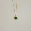 Macro detail of square emerald green zircon pendant on 18K gold plated copper chain - May