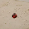 Macro view of a faceted red cushion-cut cubic zirconia gemstone birthstone charm - January-Pendant Only (Without Chain)