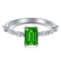Detailed macro view of an emerald-cut green gemstone ring with marquise-cut diamonds - Size 6 / Rectangle Side Stone Style / Emerald