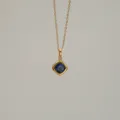 Detailed macro view of gold-plated necklace with a square sapphire blue zircon pendant. - September