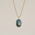 Close-up of the artistic Van Gogh Starry Night oval pendant with gold ball chain - Space