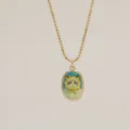 Close-up detail of a vintage gold pendant necklace with a cute hand-painted cat motif - Cat