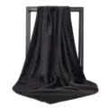 Macro view showing smooth dark satin silk square scarf draped over minimalist frame - 90*90cm / Black