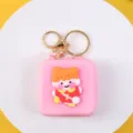 Cute pink silicone mini coin purse featuring a cartoon girl character and gold keychain - Pink Base Little Girl