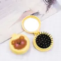 Compact yellow travel hairbrush featuring a cute cartoon bear design and a makeup mirror - Yellow Box - Blush Bear / Cartoon Folding Air Cushion Combs