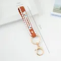 Stylish orange PVC silicone wrist strap keychain with scalloped edges, size 17cm x 1.9cm - Solid Color / Dark Brown