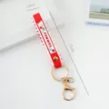 Red and white PVC silicone wristband keychain featuring gold hardware and SUMMER print - Solid Color / Red