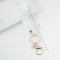 Mint green soft PVC wristband keychain featuring scalloped edges and Summer print - Translucent Style / Light Blue