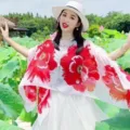 Model wearing a lightweight summer shawl with large red floral prints in a lotus pond - Tops / White Peony
