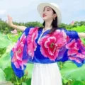 Close-up of vibrant floral sun protection shawl with elegant pearl-trimmed neckline - Tops / Royal Blue Peony