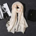 Macro view of cream pearl luster cotton linen scarf with elegant drape texture - 180x80cm / Beige