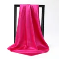 Detailed view of a vibrant hot pink silk-like square scarf with elegant satin finish - 90*90cm / Rose Red