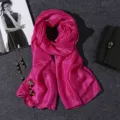 Macro view of a bright pink cotton linen scarf featuring an elegant shimmer texture - 180x80cm / Rose Red