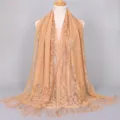 Detail view of breathable nylon lace shawl with hollow-out pattern and tassels. - 170x65cm / Camel