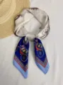 Detailed view of the elegant carriage print on a 70cm blue and white silk scarf. - Carriage Royal Blue