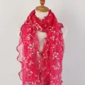 Detailed view of magenta floral long scarf featuring ruffled lettuce edges on mannequin - Rose Red