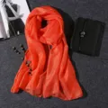 Macro shot of a vibrant orange lightweight scarf with shimmering pearlescent texture - 180x80cm / Orange Red