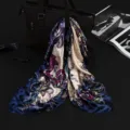 Detail of a 90cm paisley silk-like satin square scarf with elegant drape - Elegant Navy Blue