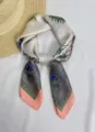 Detail of elegant silk scarf featuring vintage horse carriage print and pastel tones - Carriage Grey