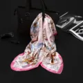 Detailed view of elegant pink floral faux silk square scarf draped over a black bag. - Misty Green