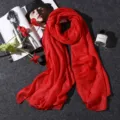 Elegant red cotton linen scarf displayed with lifestyle props on dark grey background - 180x80cm / Red