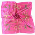Detail of a bright magenta square scarf with golden equestrian chain patterns. - Vintage Rose Equestrian Chain (Style 7)