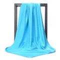 Detailed view of the smooth silk texture and drape of the 90cm light blue square scarf - 90*90cm / Lake Blue