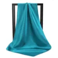 Detail showing the elegant drape and shiny satin texture of a peacock blue square scarf - 90*90cm / Teal