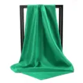 Close-up of vibrant emerald green silk scarf draped elegantly over a minimal black frame - 90*90cm / Verdant