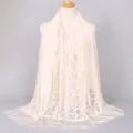 Elegant beige lace scarf featuring intricate floral hollow design and fringe details - 170x65cm / Beige