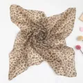 Detail view of a professional leopard print silk scarf for business etiquette uniforms. - Light Leopard