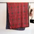Detail view of reversible mulberry silk scarf with traditional patterns and hand-rolled edges - 180cm / Red And Dark Blue Double Sided Floral (1)
