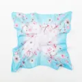 Detailed view of an elegant light blue floral square silk scarf for professional uniforms - Blue White Gradient Magnolia