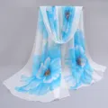 Elegant detail view of lightweight chiffon scarf with large blue floral print for summer - Blue