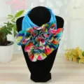 Vibrant multicolor ruffled neck warmer scarf for women displayed on a black mannequin - Blue / One Size