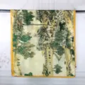 Detail showing the traditional Chinese landscape painting on a yellow-bordered scarf. - Riverside Painting Green / 90x180cm
