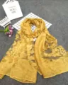 Close-up of golden yellow sheer scarf with intricate floral burnout texture and sheer fabric - Yellow