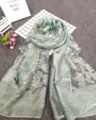 Close-up detail of a mint green devore scarf featuring intricate floral patterns and textures - Bean Green